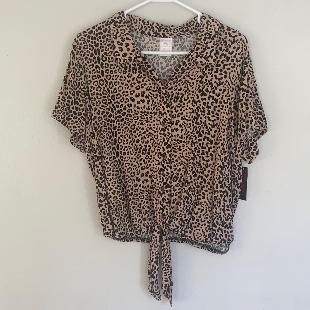 Cheetah print top with a tie at the bottom. Brand new with tags still on.